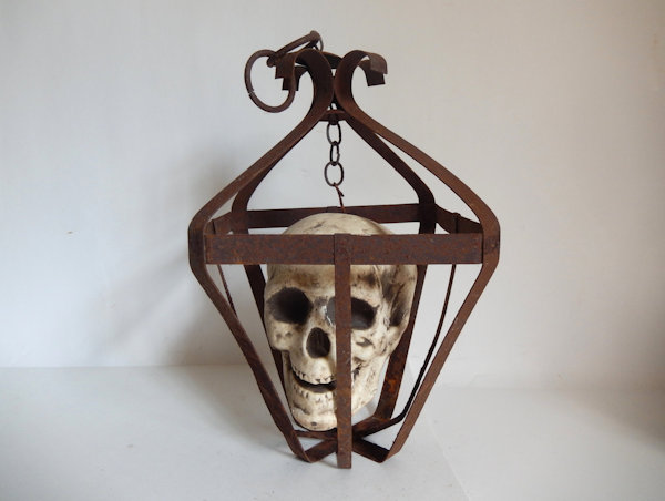 Human Skull in Rusted Metal Cage